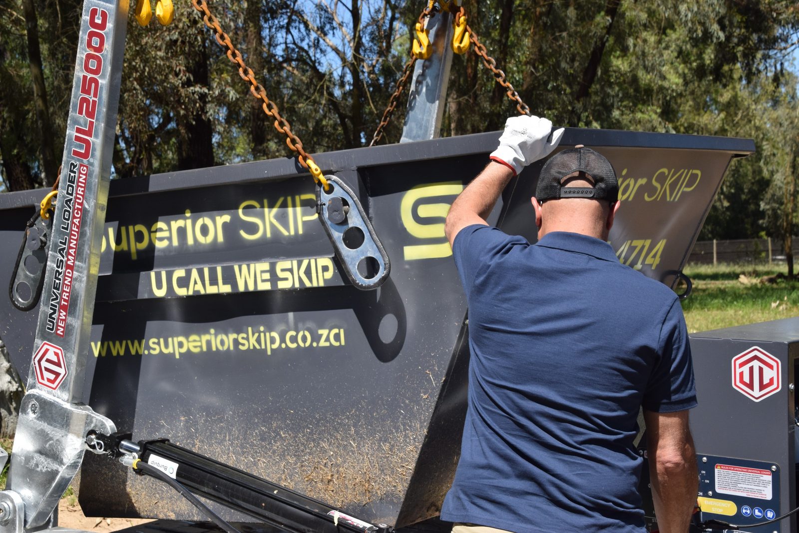 Superior Skip crew loading a skip bin onto the trailer
