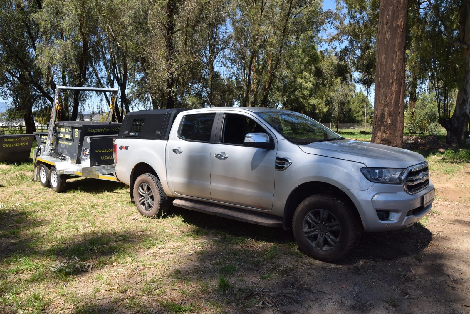 Superior Skip bakkie towing a loaded skip trailer